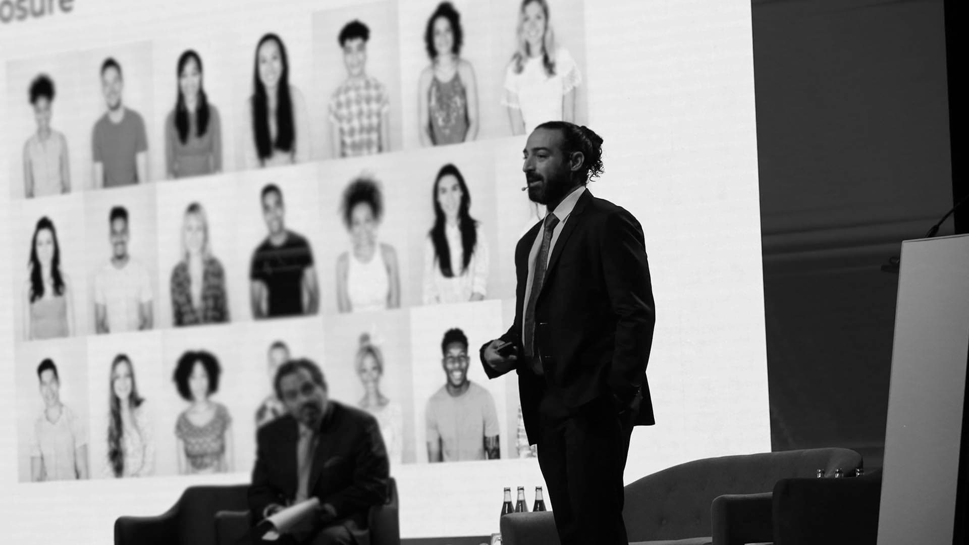 alt="Dr. Rami Haidar speaking at an international aesthetic medicine workshop, sharing expertise in facial rejuvenation techniques"